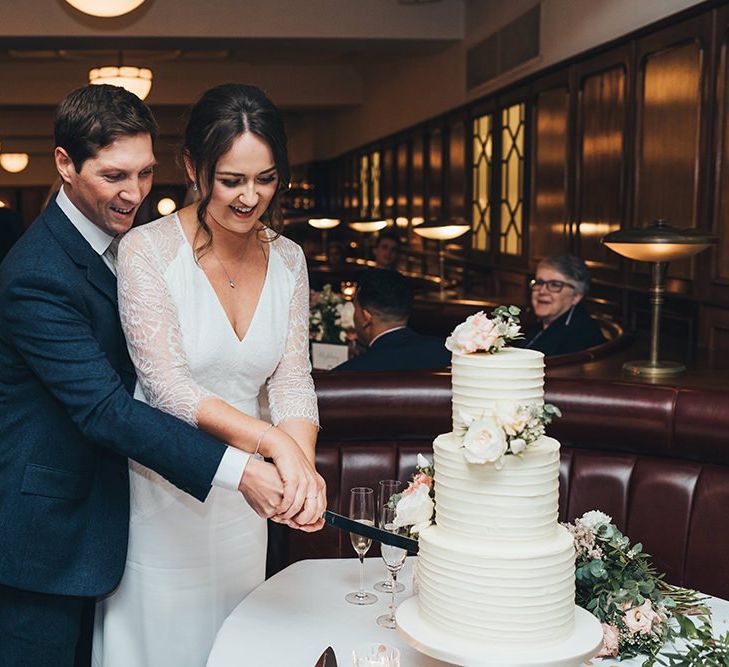 Bride and Groom Cutting The Wedding Cake