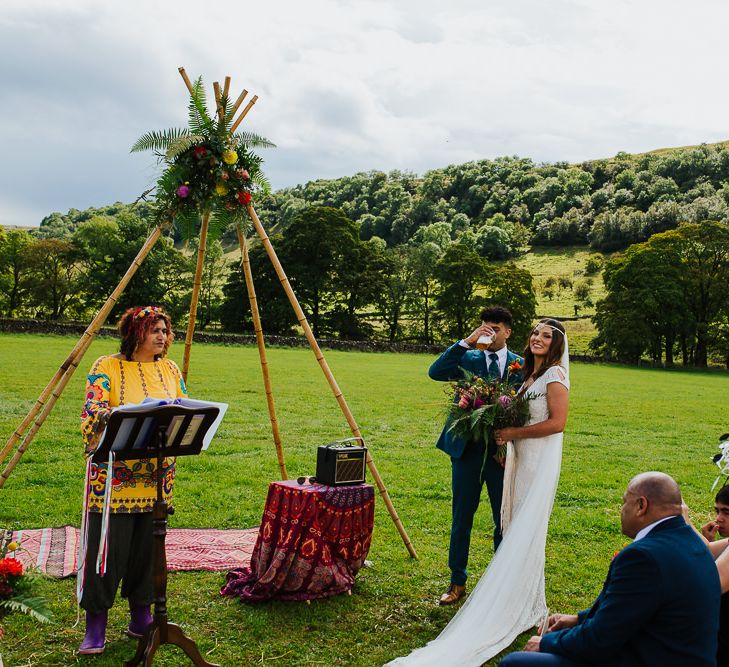 Wedding Ceremony |  Bride in Daughters of Simone Lace Gown | Groom in Tweed Suit | Brightly Coloured Festival Wedding with Outdoor Humanist Ceremony &amp; Tipi Reception on the Yorkshire Dales | Tim Dunk Photography