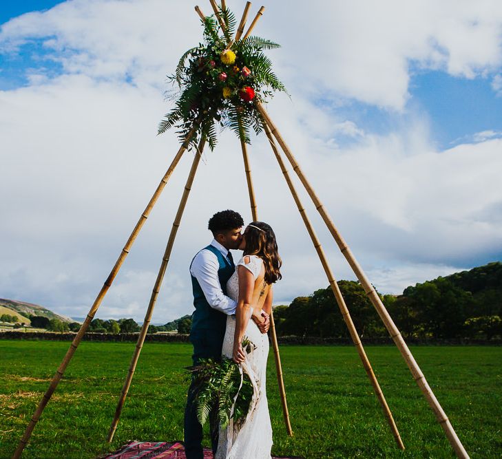 Naked Tipi |  Bride in Daughters of Simone Lace Gown | Groom in Tweed Suit | Brightly Coloured Festival Wedding with Outdoor Humanist Ceremony &amp; Tipi Reception on the Yorkshire Dales | Tim Dunk Photography