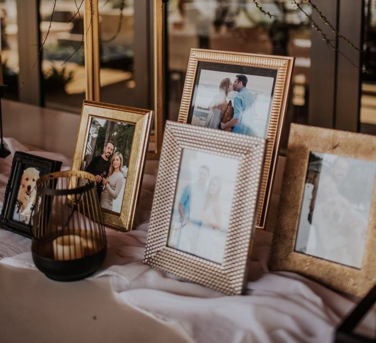 Personal wedding welcome table with photographs in frames