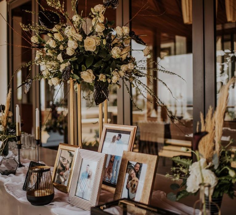 Personal wedding welcome table with photographs in frames