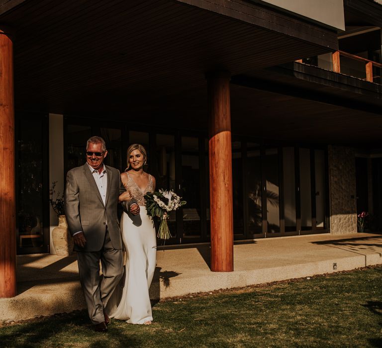 Bride is escorted to wedding ceremony