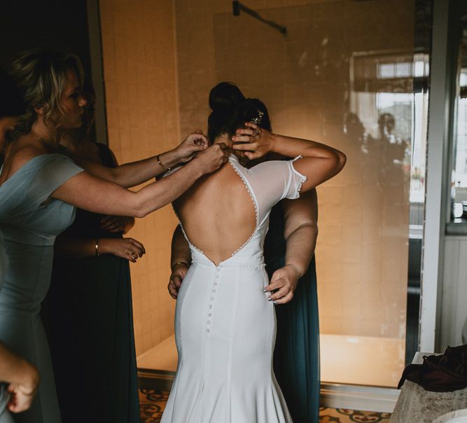 Bride Putting On Her Bespoke Wedding Dress with Keyhole Back and Button  Detail