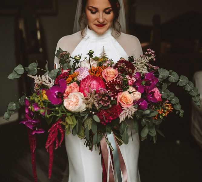 Bride in Bespoke Wedding Dress Holding a Pink Wedding Bouquet