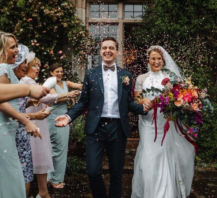 Confetti Moment with Bride in Bespoke Dress and Groom in Suit &amp; Bow Tie