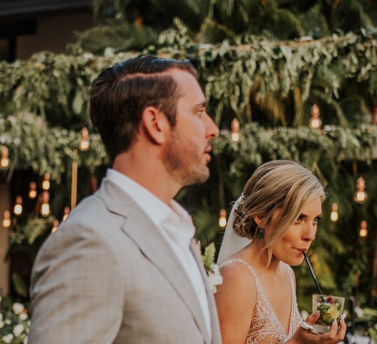 Bride and groom have a drink to celebrate their wedding