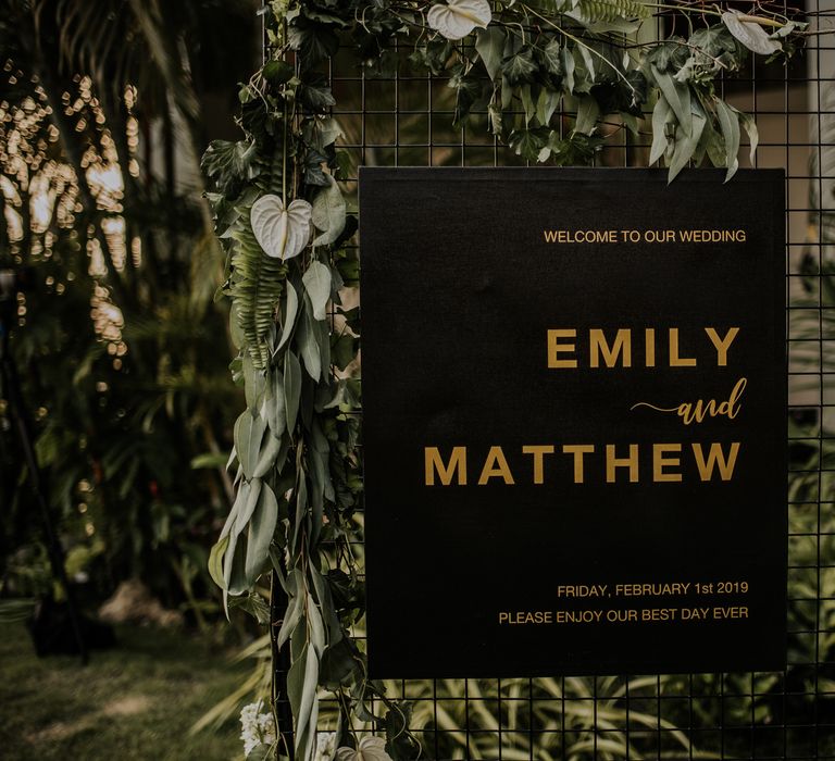 Wedding seating chart with foliage and leaf decor for industrial jungle chic Thailand wedding