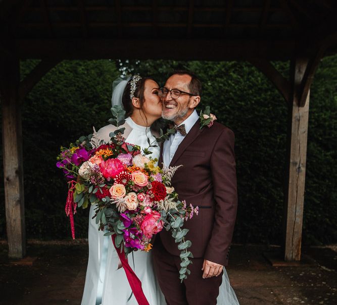 Bride and Father of the Bride in Burgundy Suit with Bride Holding a Pink Wedding Bouquet