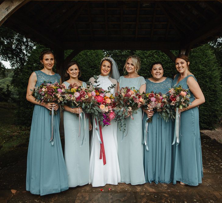 Bridal Party Portrait with Bridesmaids in Jade Green Dresses and Pink Wedding Bouquets