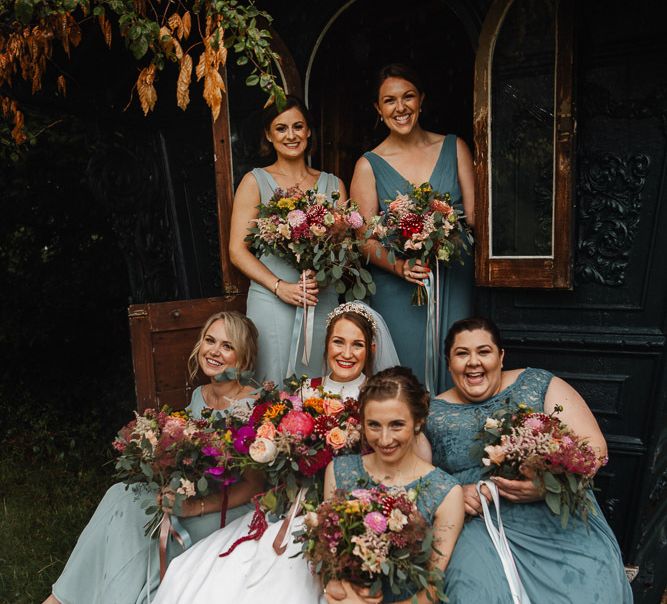 Bride and Bridesmaid Portrait at Askham Hall Wedding with Jade Green Dresses and Pink Wedding Bouquets