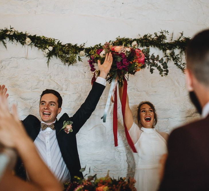 Bride and Groom Standing at the Top Table