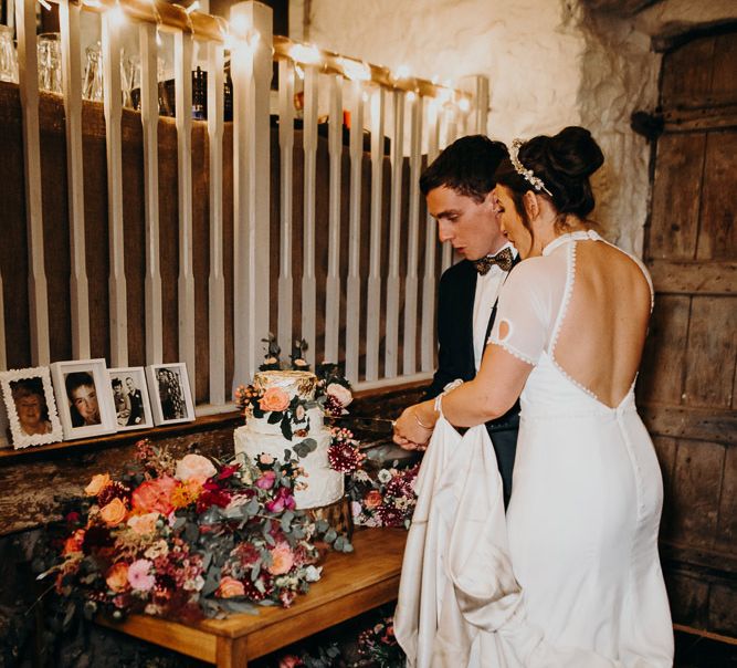 Bride and Groom Cutting the Cake at Their Askham Hall Wedding