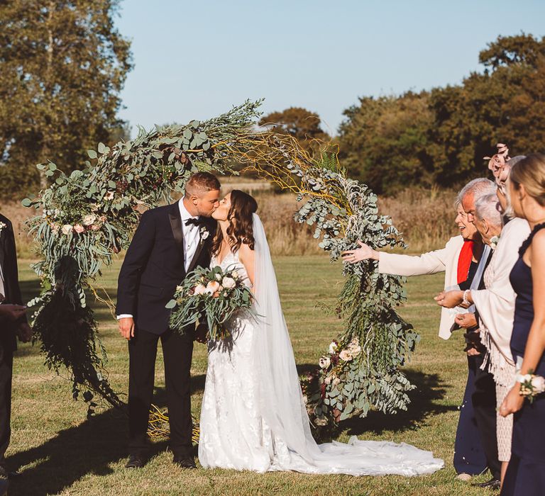 Intimate wedding ceremony at Crouchers Orchards with foliage hoop decor and eucalyptus chair decor