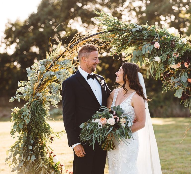 Bride wearing beautiful Made With Love Bridal dress and groom wearing black tie suit