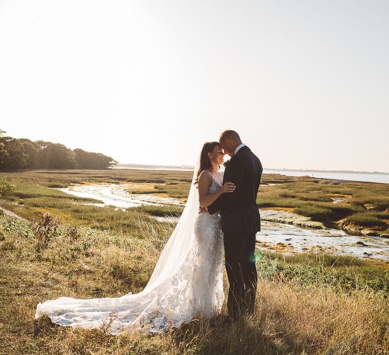 Bride and groom embrace at Crouchers Orchards for outdoor wedding