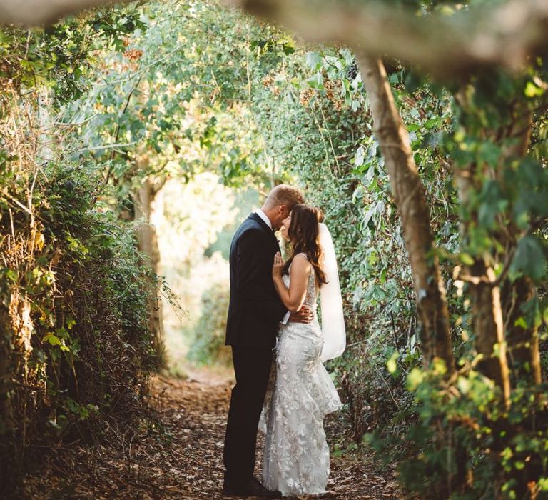 Bride and groom embrace at Crouchers Orchards for outdoor wedding