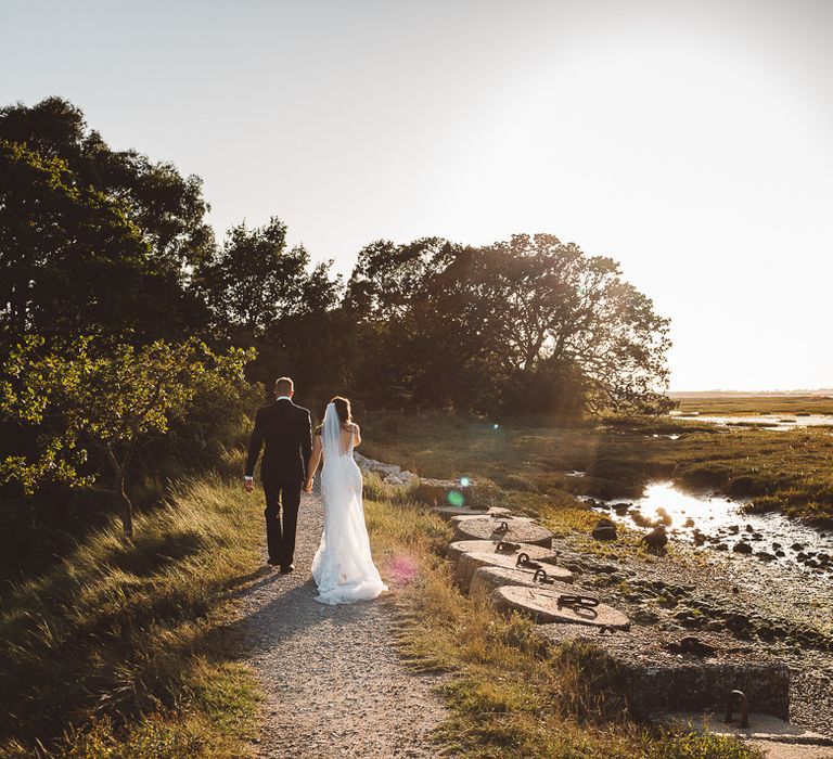 Bride and groom embrace at Crouchers Orchards for outdoor wedding