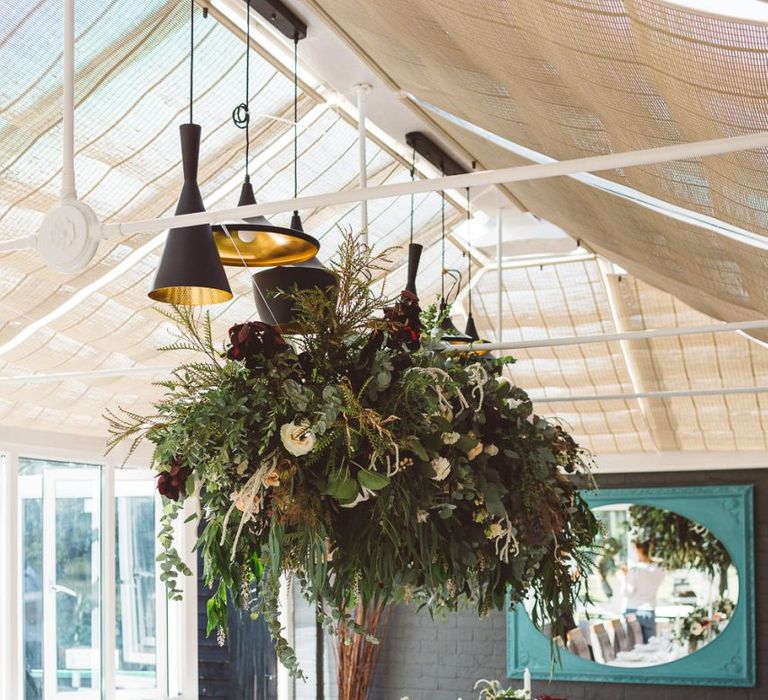 Hanging foliage styled with florals and eucalyptus for intimate reception with seven guests