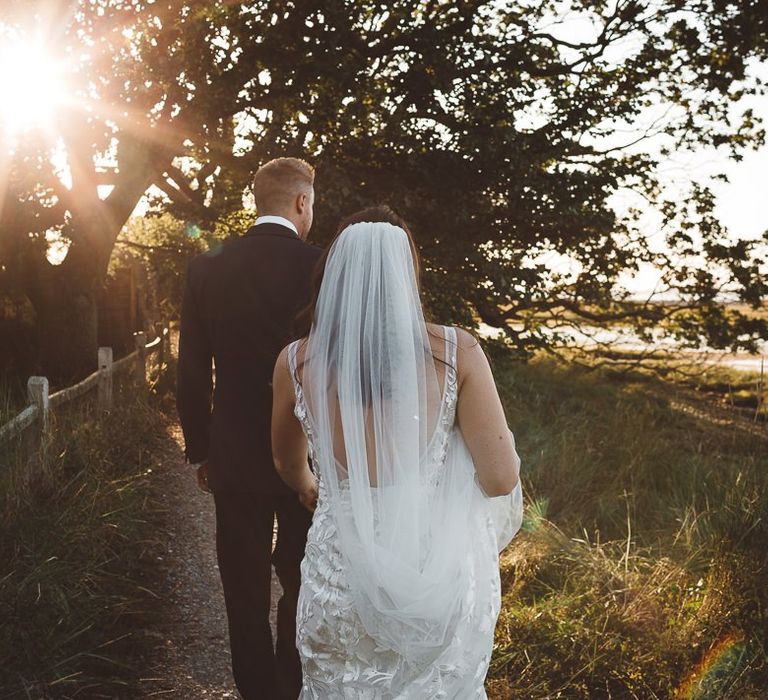 Bride and groom steal a moment together and enjoy golden hour