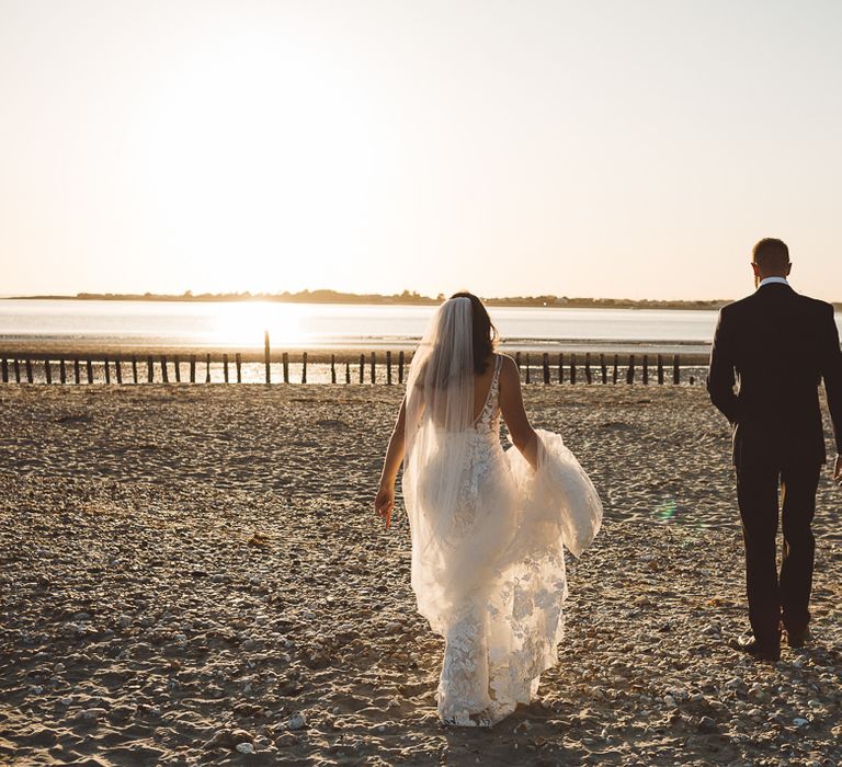 Bride and groom enjoy a beach shoot together at golden hour