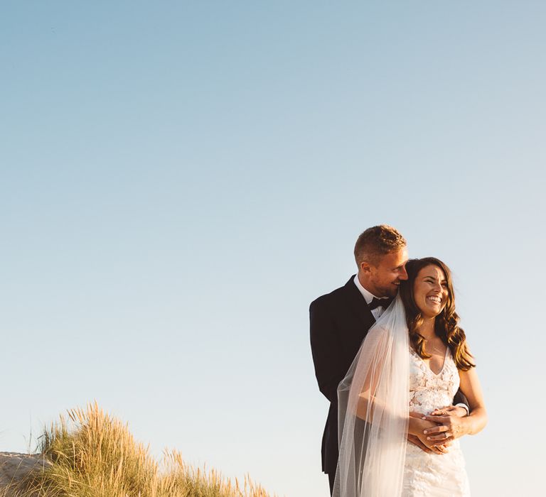 Couple embrace at romantic and intimate wedding