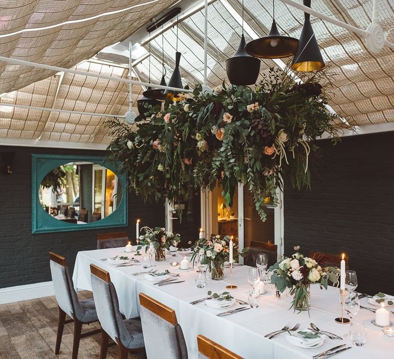 Beautiful hanging foliage styled with eucalyptus for a romantic and intimate dinner