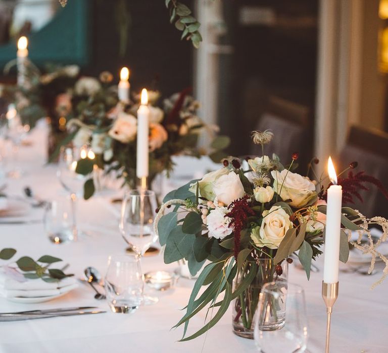 Beautiful hanging foliage styled with eucalyptus and gold candlesticks for a romantic and intimate dinner