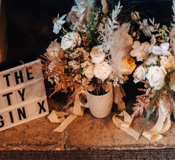 October wedding decor with dried flowers and cinema box light