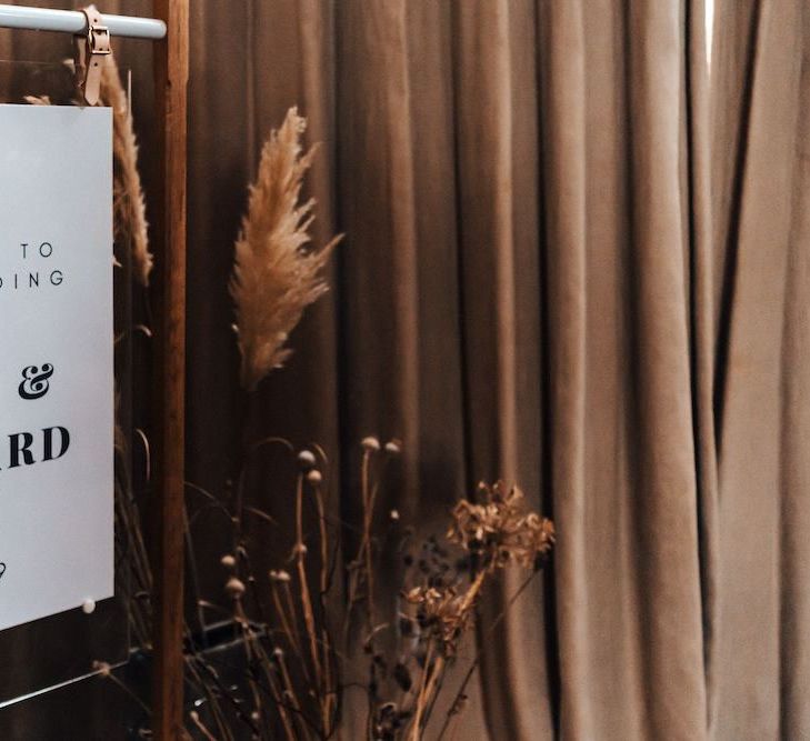 Monochrome wedding sign with pampas grass and dried flower decor at October wedding