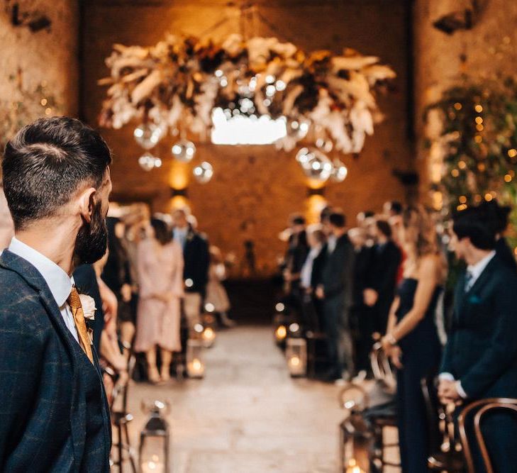 Groom waiting for bride to arrive at October wedding