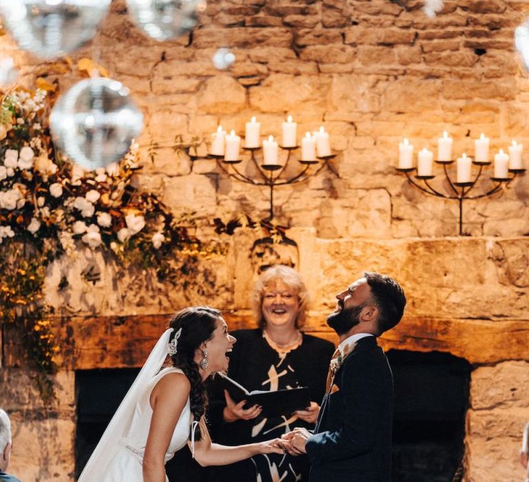 Bride and groom during October wedding ceremony at Cripps Barn