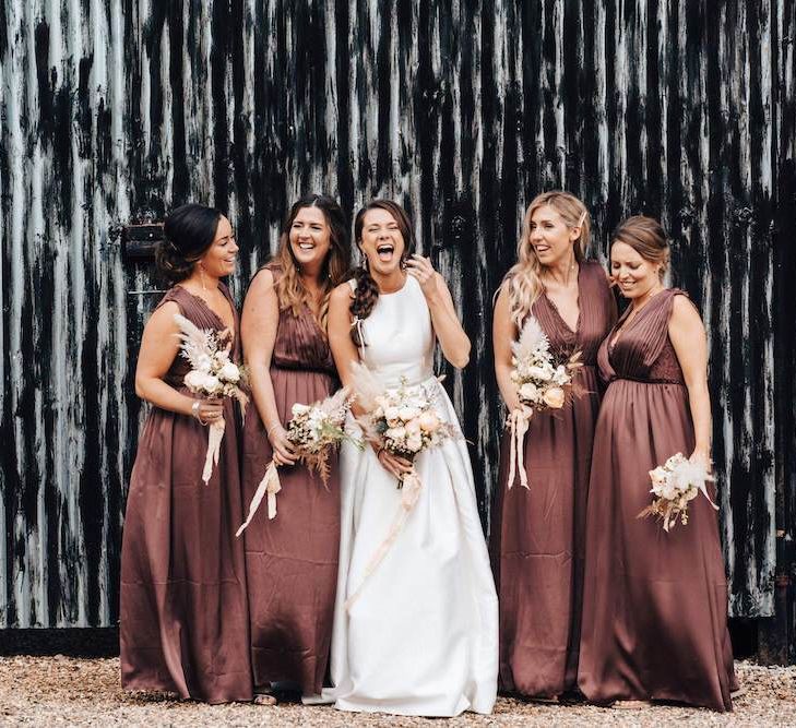 Brown bridesmaid dresses with dried flower bouquets