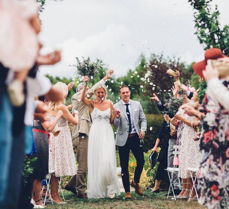 Confetti Moment | Bride in Needle &amp; Thread Gown | Groom in Reiss Chinos &amp; Blazer | Outdoor Destination Wedding at Le Peit Hameau Wedding Venue Provence, South of France Planned by By Mademoiselle | Lovestruck Photography