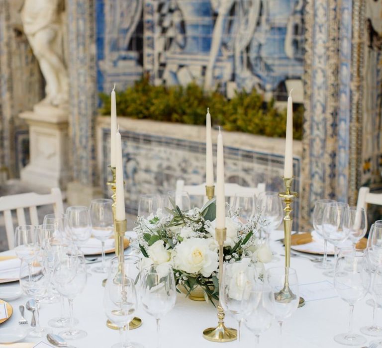 Table Decor with Gold Candlesticks and White Floral Arrangement