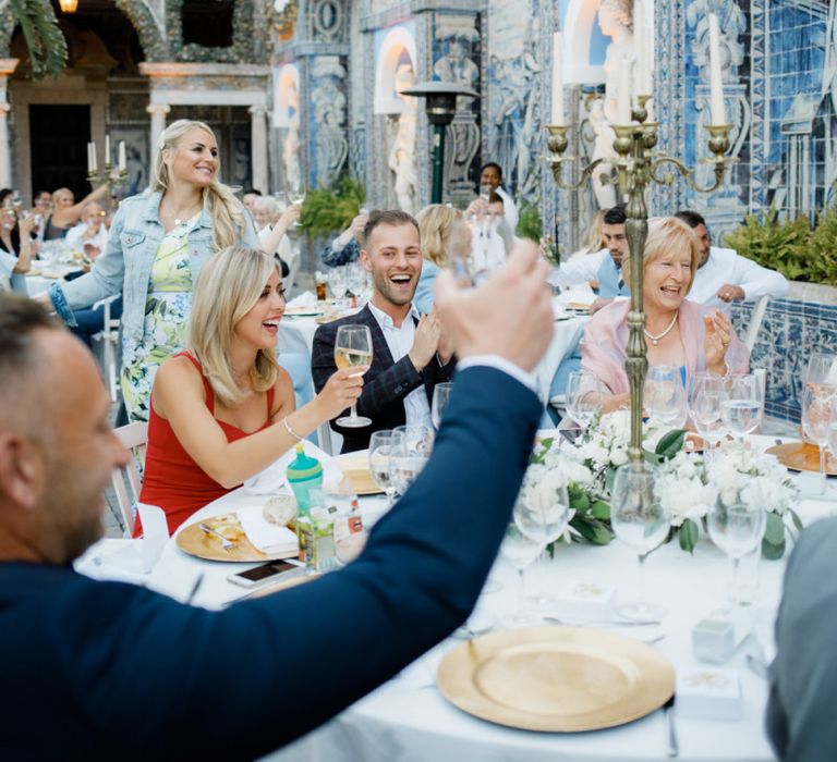 Wedding Guests Raising Their Glasses at the Reception