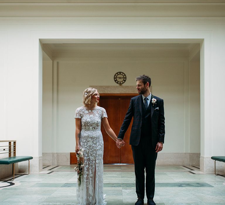 Stylish Bride in Lace Hermione De Paula Wedding Dress and Groom in Ted Baker Suit at Hackney Town Hall