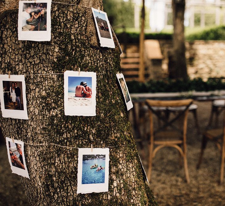 Polaroid Pictures Hung Around a Tree | Wedding Decor | Stylish Tuscan Wedding at Vignamaggio Planned by The Wedding Boutique Italy | Samuel Docker Photography | Paul Vann Films