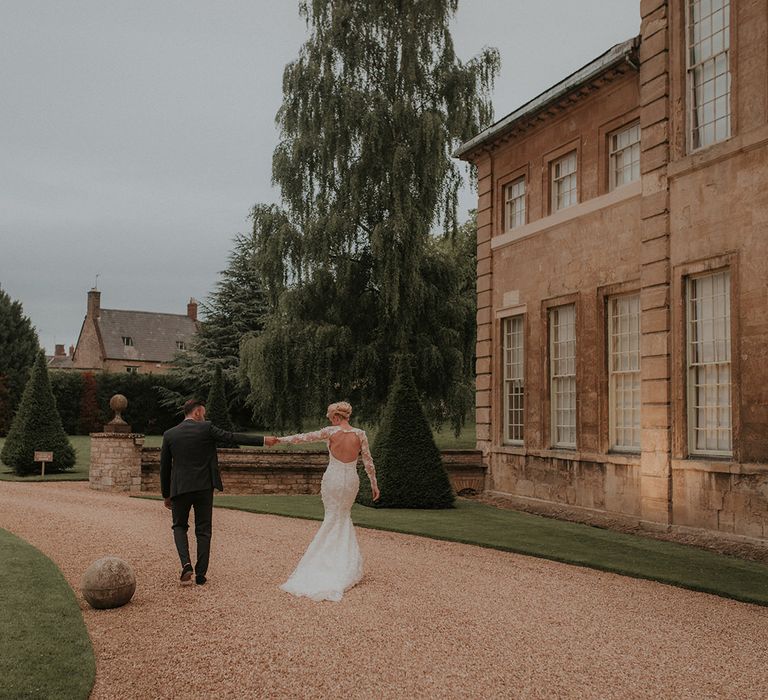 Bride in Suzanne Neville wedding dress with open back