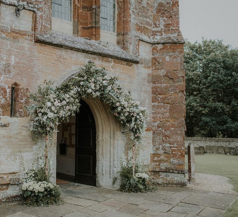 Church wedding decor and flower arch at entrance