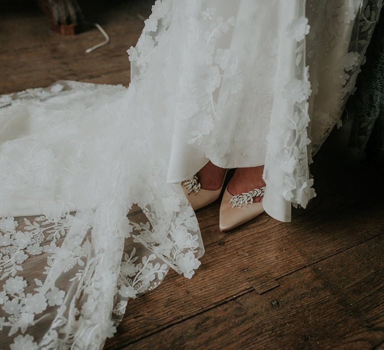 Lace detail Suzanne Neville wedding dress with blush wedding shoes