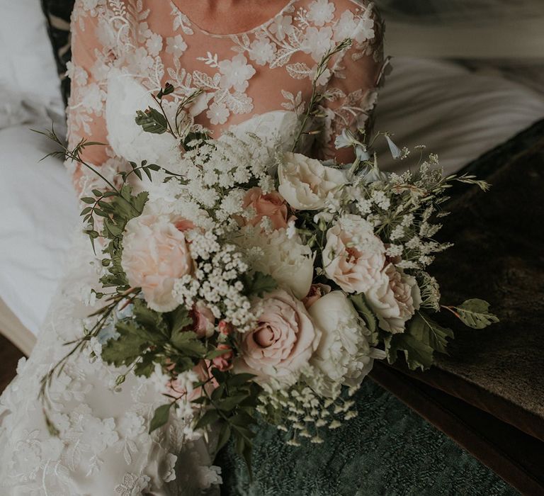 Applique bespoke Suzanne Neville wedding dress with blush bridal bouquet