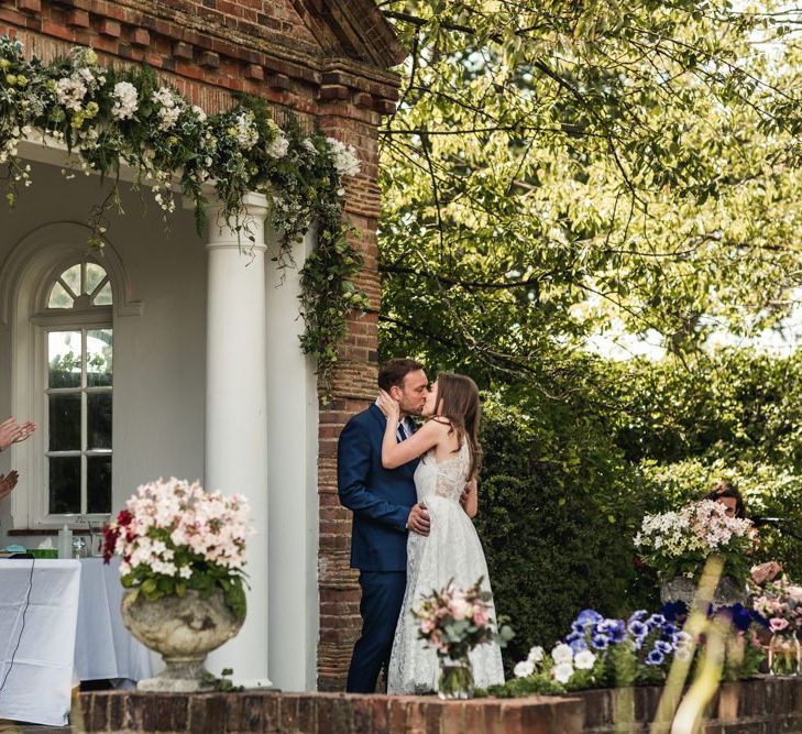 Bride and groom kissing at their Micklefield Hall wedding