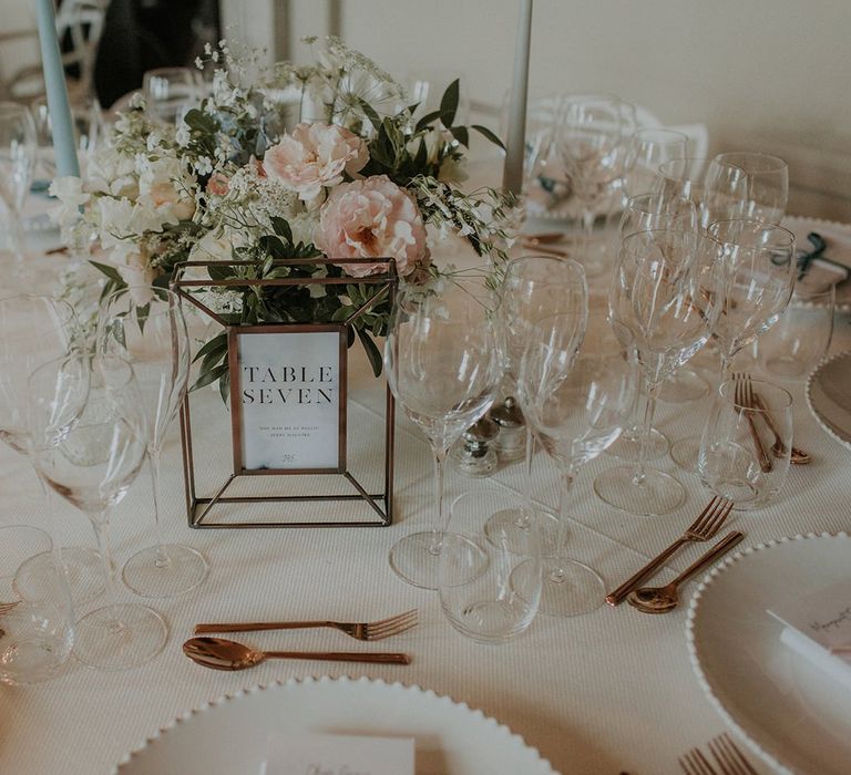 Wedding table decor with framed table numbers and blush flowers