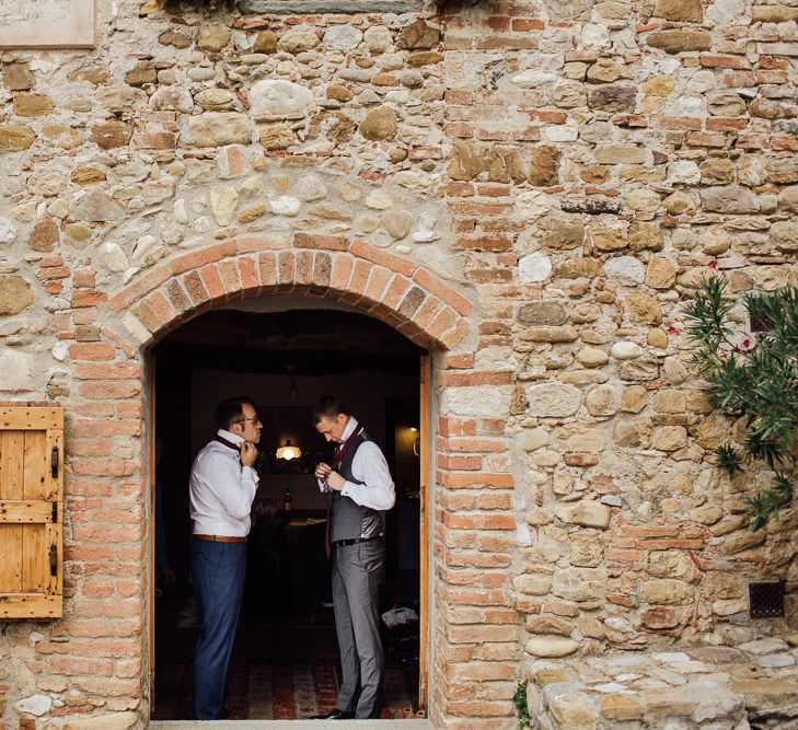 Groom's morning preparations. Destination wedding in Italy. Featuring RMW The List recommended suppliers Wiskow &amp; White and Red on Blonde. Rue de Seine wedding gown with deep red chianti bridesmaid Rewritten dresses.