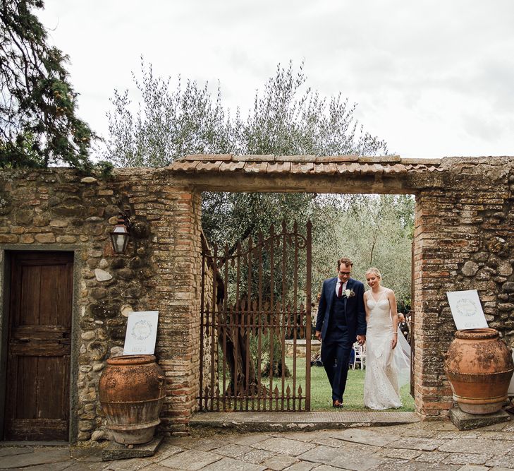 Ceremony in  Castle gardens. .Destination wedding in Italy. Featuring RMW The List recommended suppliers Wiskow &amp; White and Red on Blonde. Rue de Seine wedding gown with deep red chianti bridesmaid Rewritten dresses.