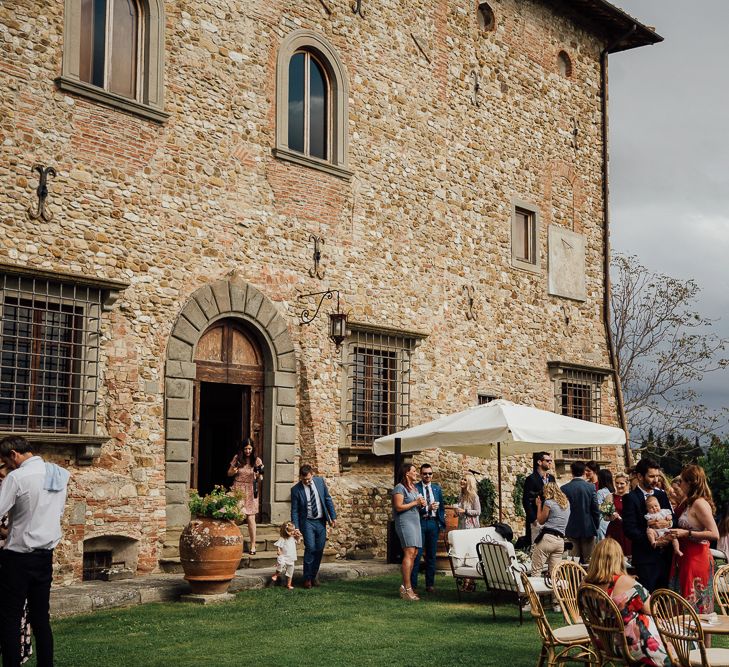 Castle grounds. Destination wedding in Italy. Featuring RMW The List recommended suppliers Wiskow &amp; White and Red on Blonde. Rue de Seine wedding gown with deep red chianti bridesmaid Rewritten dresses.