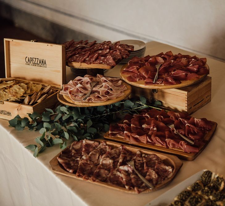 Platters of Charcuterie. Destination wedding in Italy. Featuring RMW The List recommended suppliers Wiskow &amp; White and Red on Blonde. Rue de Seine wedding gown with deep red chianti bridesmaid Rewritten dresses.