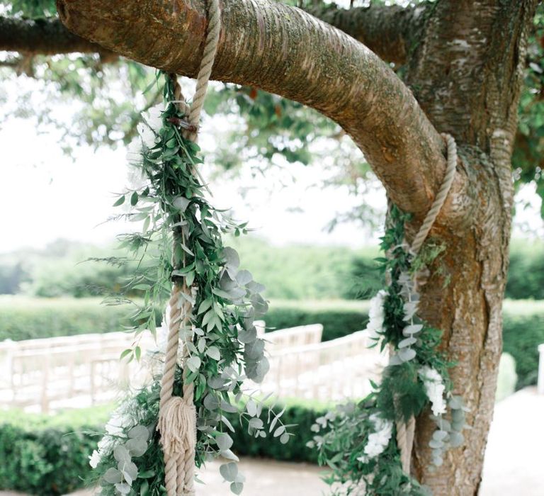 Swing at Froyle Park wedding covered in foliage and white flowers