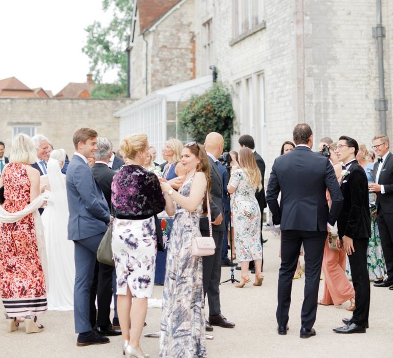 Wedding guests gathered outside Froyle Park