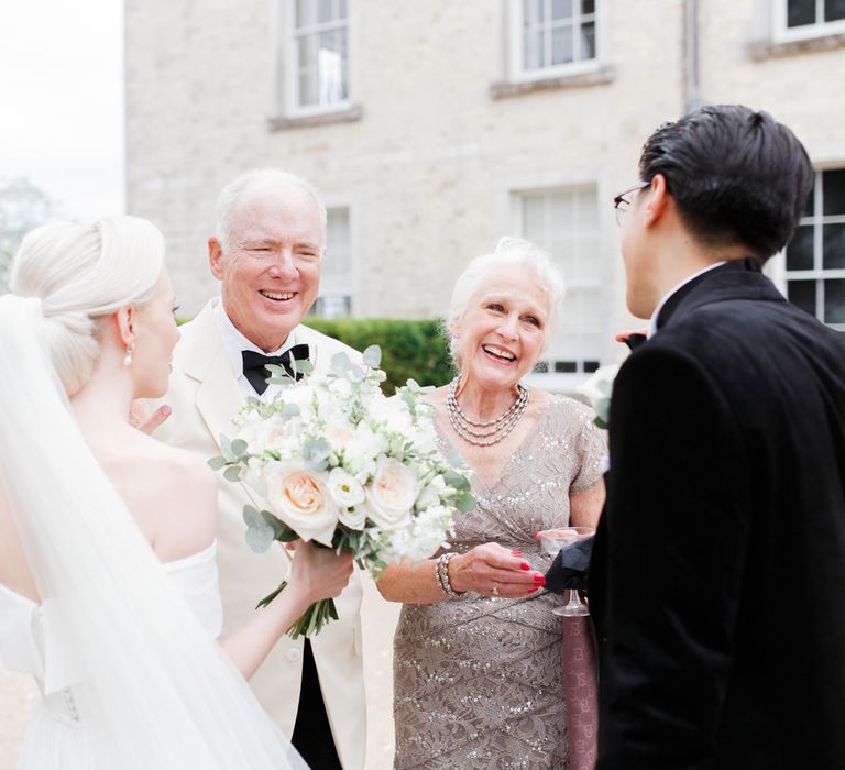 Bride and groom talking to family